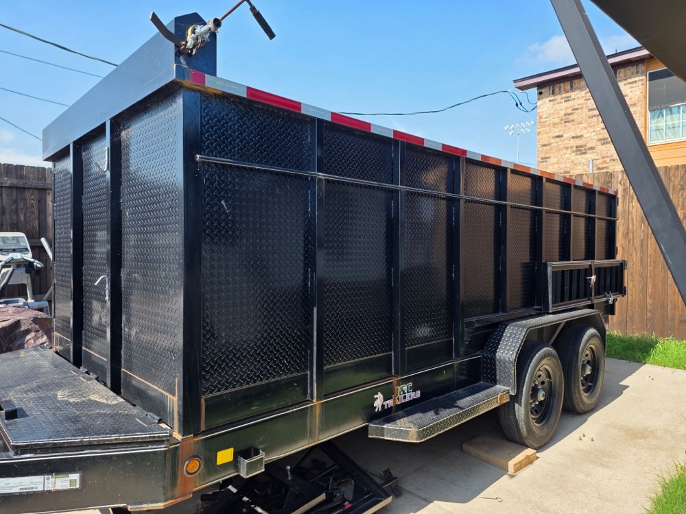 Side view of the 16ft Silverback Rental dump trailer with high walls extended